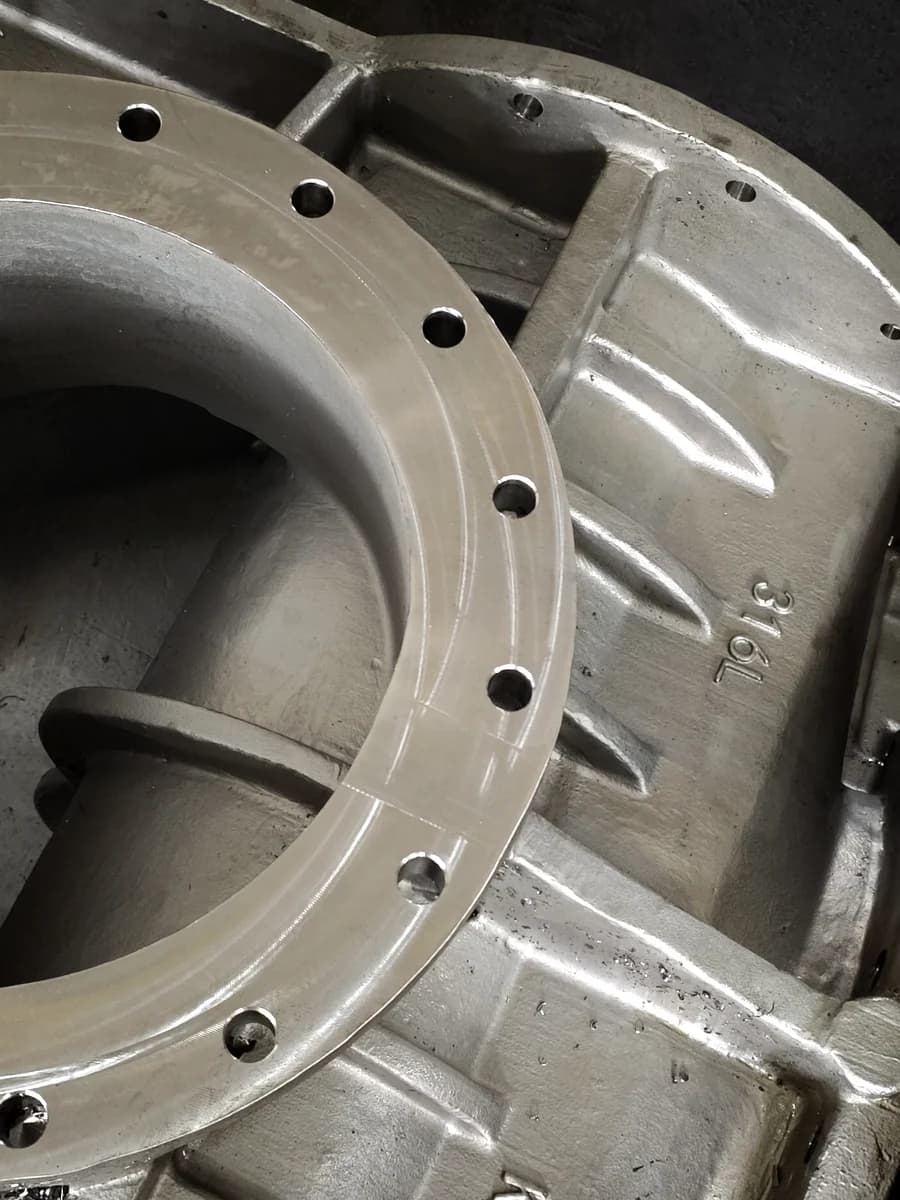 Machined stainless steel industrial component with finished flange surfaces